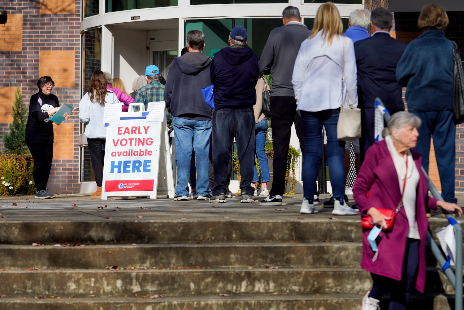 Fulton county residents take advantage of early voting Monday morning in Atlanta. Lines stretched out the door at the Northside branch library on Monday, Nov. 28, 2022.  (Ben Hendren for the Atlanta Journal Constitution) 