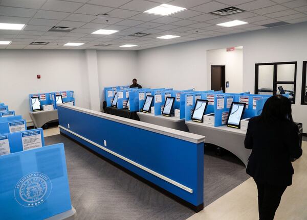 Gwinnett County poll workers walk through the voting area at the Gwinnett County Voter Registrations and Elections office building during early voting for the presidential primary in Lawrenceville, Monday, March 2, 2020. (Alyssa Pointer/AJC)