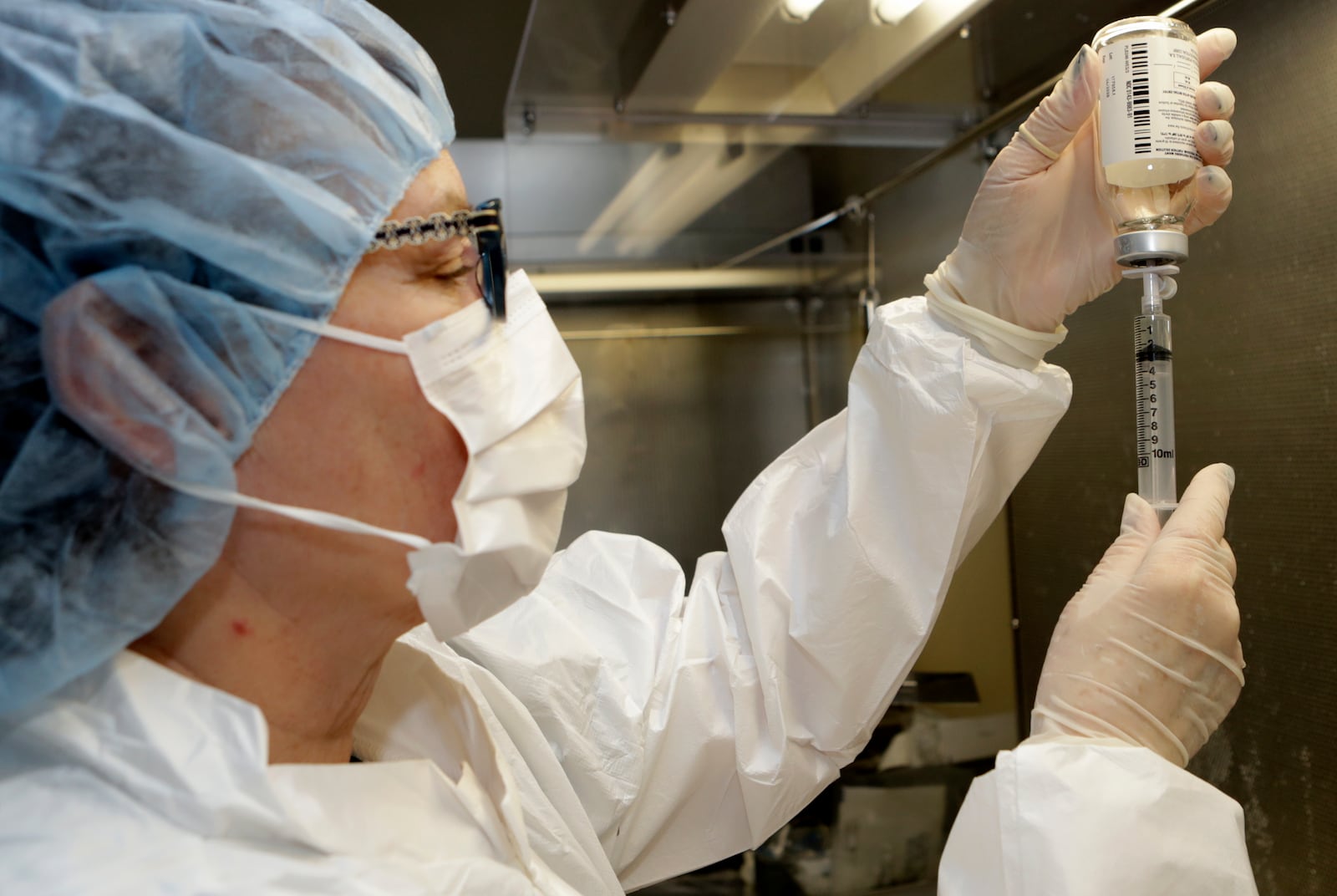 Certified pharmacy technician Peggy Gillespie fills a syringe with antibiotics for use as an I.V. push at ProMedica Toledo Hospital in Toledo, Ohio. (AP Photo/Tony Dejak)