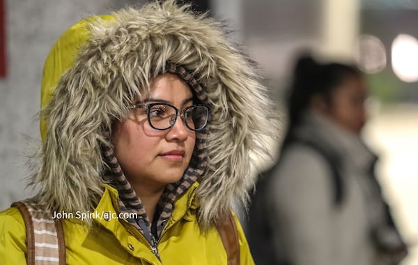 Sara Martinez waits in the cold at the North Avenue MARTA station on Monday morning.