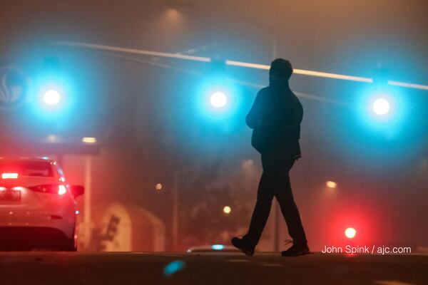 Tina Harris crossed Central Avenue on her way to work early Monday. JOHN SPINK / JSPINK@AJC.COM