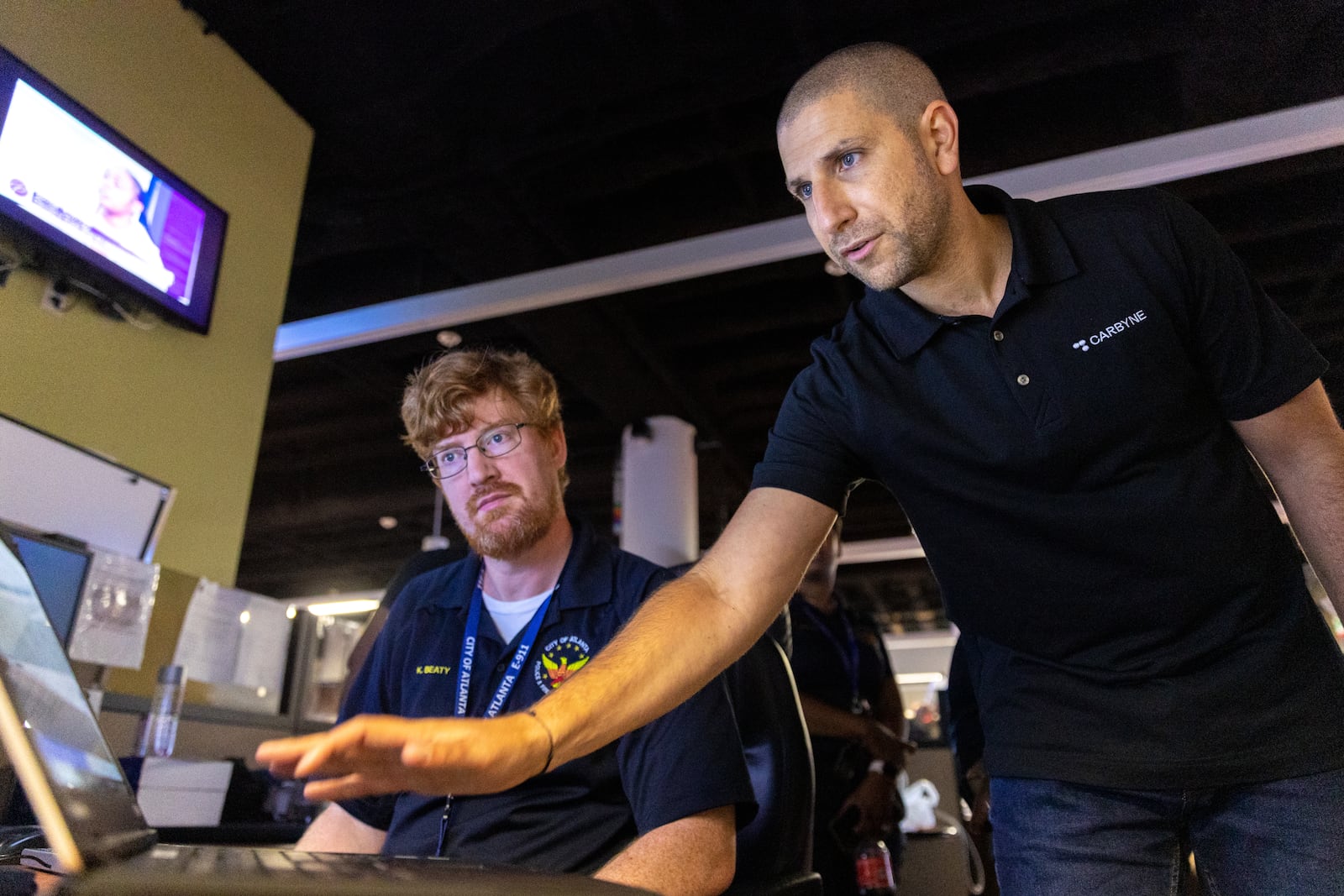 Carbyne CEO Amir Elichai (right) demonstrates the new software system at Atlanta’s E-911 center.