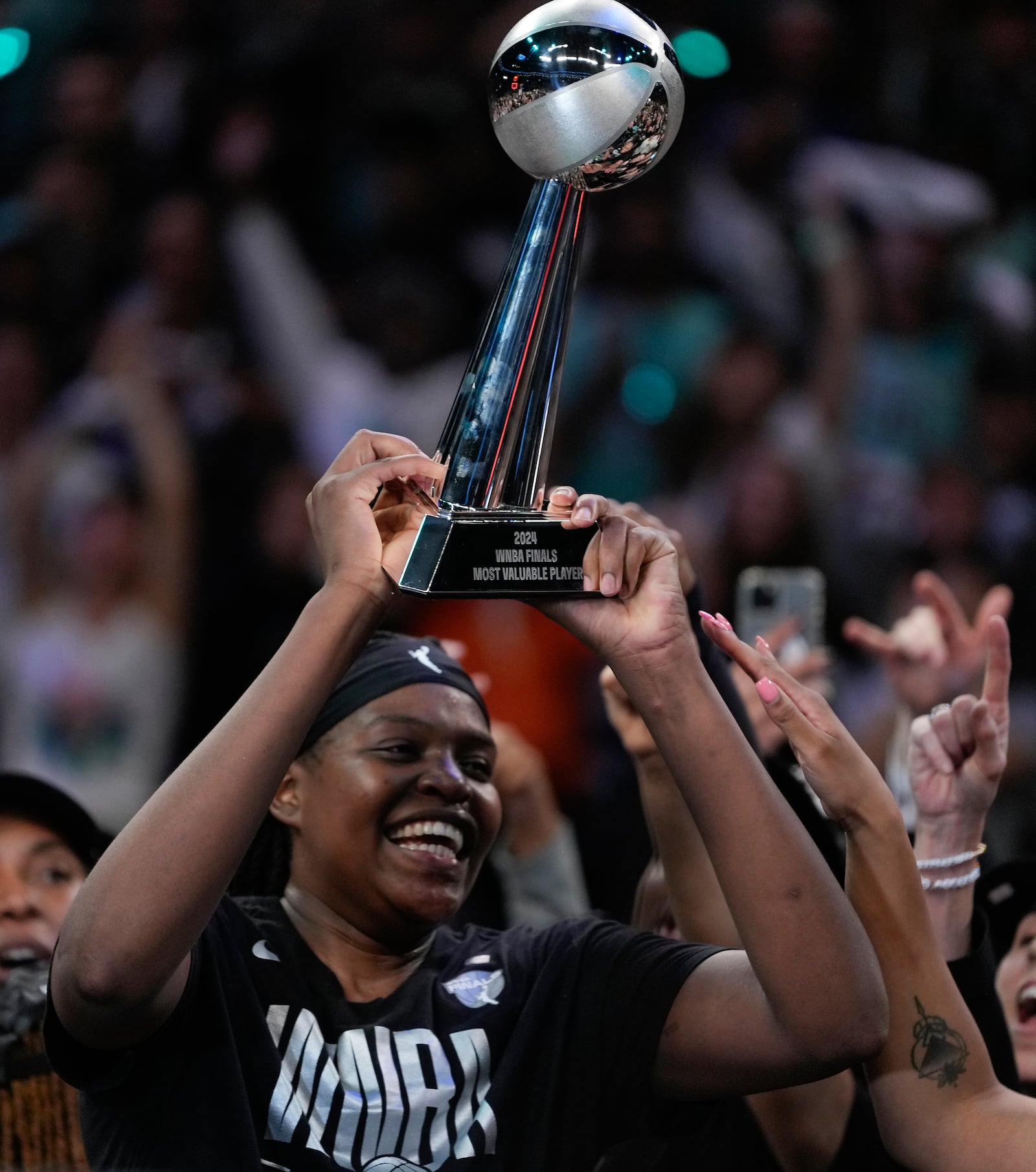 New York Liberty forward Jonquel Jones reacts after being given the MVP Award after winning the championship against the Minnesota Lynx in Game 5 of the WNBA basketball final series, Sunday, Oct. 20, 2024, in New York. (AP Photo/Pamela Smith)