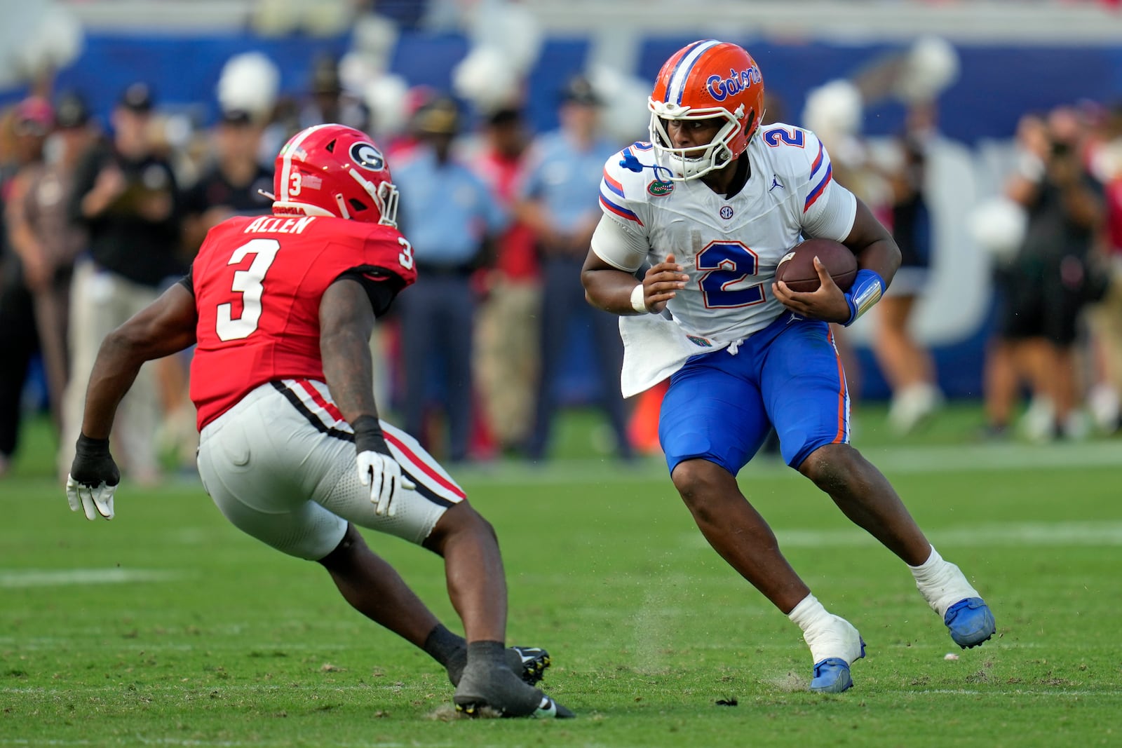 Florida quarterback DJ Lagway (2) looks for a way past Georgia linebacker CJ Allen (3) during the first half of an NCAA college football game, Saturday, Nov. 2, 2024, in Jacksonville, Fla. (AP Photo/John Raoux)