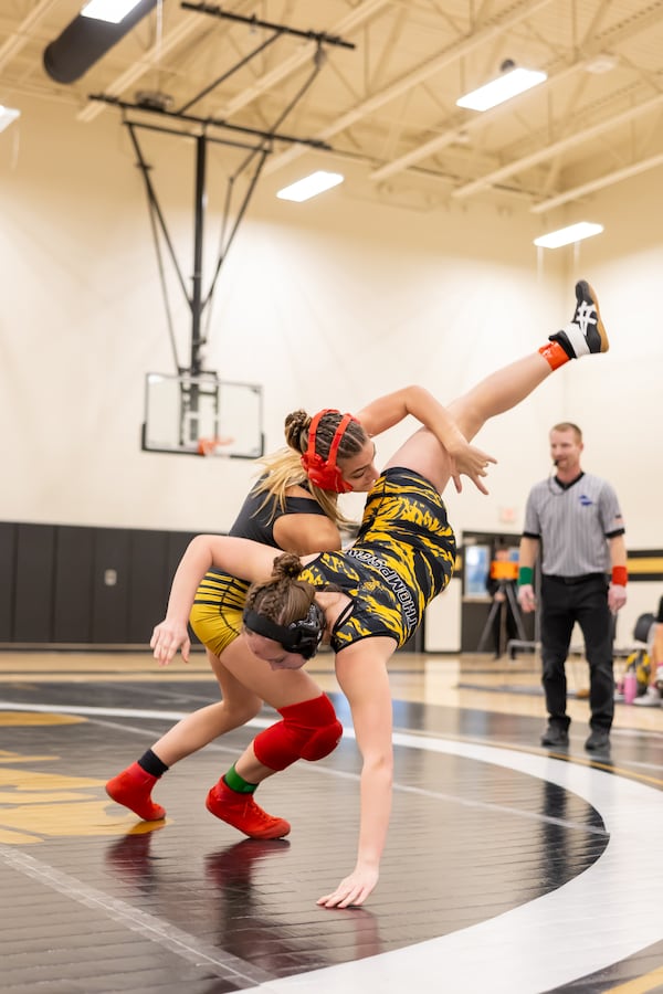 Bailey Moore, here slamming an opponent, competes in the 105-pound division for the Carrollton girls wrestling team. (Photo by Brian Carmicheal)