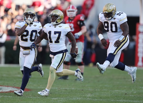 Georgia Tech defenisve tackle Brandon Adams (90) celebrated a critical Yellow Jackets interception by Lance Austin (17) in Tech’s win over Georgia in 2016 in Athens. 