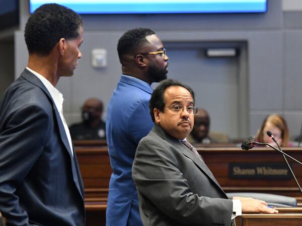 Michel "Marty" Turpeau IV, chairman of DAFC, standing with Sam Bacote (left), treasurer of DAFC and Kyle Lamont (second from left), member of DAFC at the Fulton County government building in July. Turpeau says developments granted tax breaks ultimately add tax revenue and stimulate economic growth.  (Hyosub Shin / Hyosub.Shin@ajc.com)