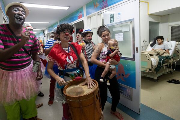 Clowns from the "Roda de Palhacos" cultural project perform during a carnival party in the pediatric area of the Servidores do Estado Federal Hospital in Rio de Janeiro, Tuesday, March 11, 2025. (AP Photo/Bruna Prado)