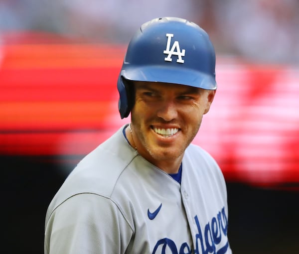 Former Atlanta Braves first baseman Freddie Freeman smiles at the Braves dugout after drawing a walk against the Braves during the first inning of a MLB baseball game on Friday, June 24, 2022, in Atlanta.  “Curtis Compton / Curtis.Compton@ajc.com”