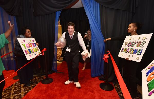 Jason Reynolds reacts on the red carpet as volunteers cheer for him during the “Night to Shine” event at First Baptist Church Atlanta in Dunwoody on Feb. 8. The event, which is sponsored by the Tim Tebow Foundation and happens in all 50 states and 16 countries, provides a prom night experience for people with special needs. HYOSUB SHIN / HSHIN@AJC.COM