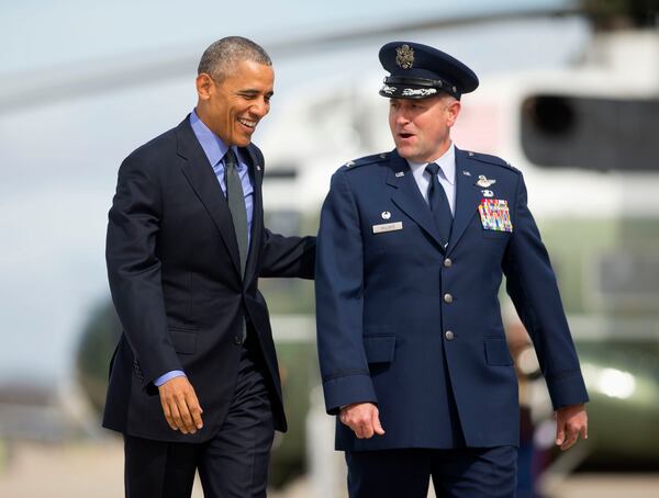 President Barack Obama walks across the tarmac with Commander of 89th Airlift Wing Col. John Millard prior to boarding Air Force One before his departure, Friday, March 11, 2016, from Andrews Air Force Base, Md. Obama is traveling to Austin, Texas to speak at South by Southwest Festival (SXSW) and attend 2 Democratic National Committee fundraisers. (AP Photo/Pablo Martinez Monsivais)