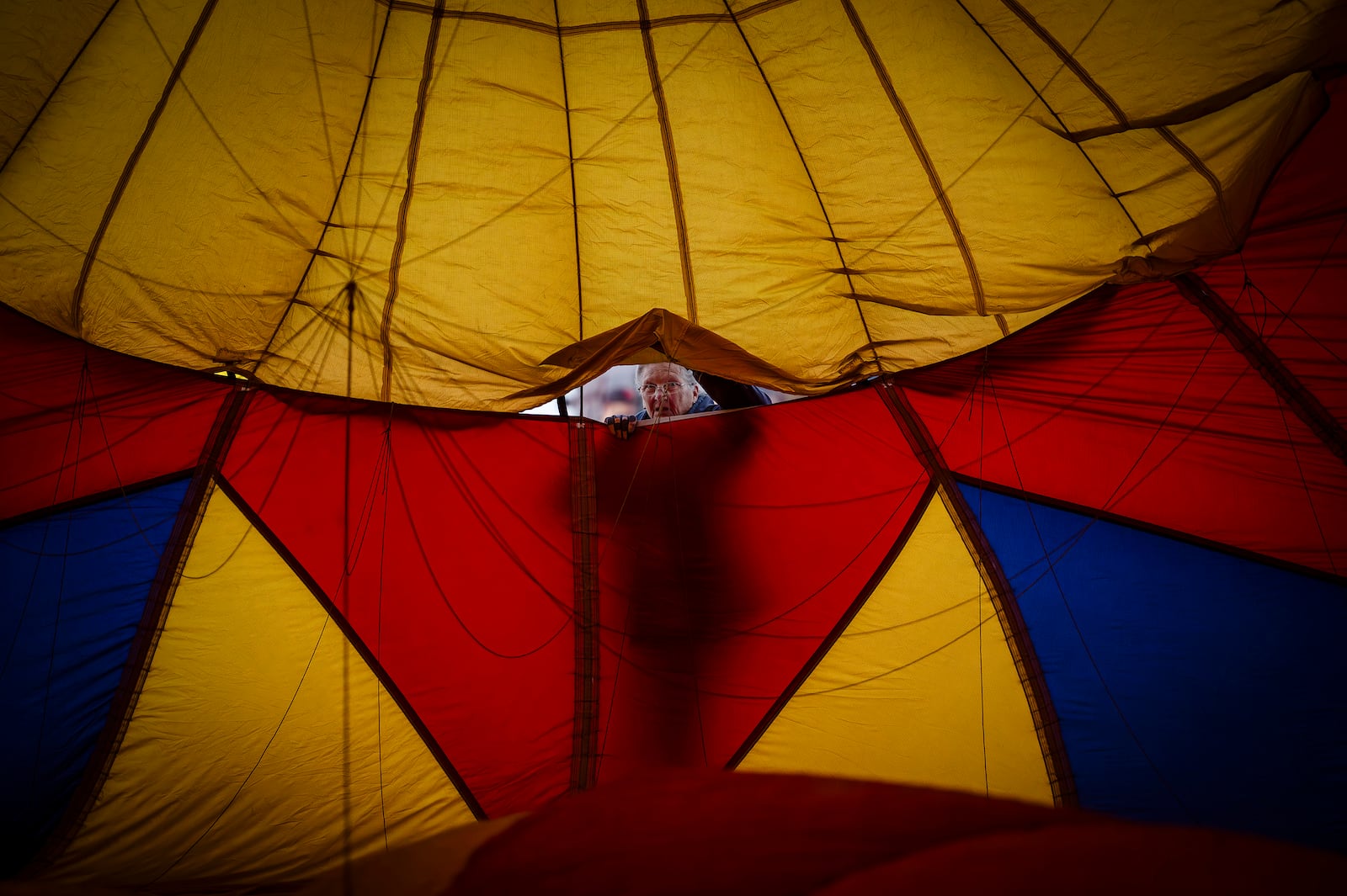 Denise Morgan helps set up the Saki Bomber hot air balloon during Albuquerque Aloft event at Dennis Chavez Elementary School in Northeast Albuquerque, N.M., on Friday, Oct. 4, 2024. (Chancey Bush/The Albuquerque Journal via AP)