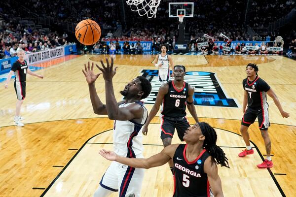 Gonzaga forward Graham Ike, center left, beats Georgia guard Silas Demary Jr. (5) to a rebound during the second half of the first round of the NCAA college basketball tournament, Thursday, March 20, 2025, in Wichita, Kan. (AP Photo/Charlie Riedel)