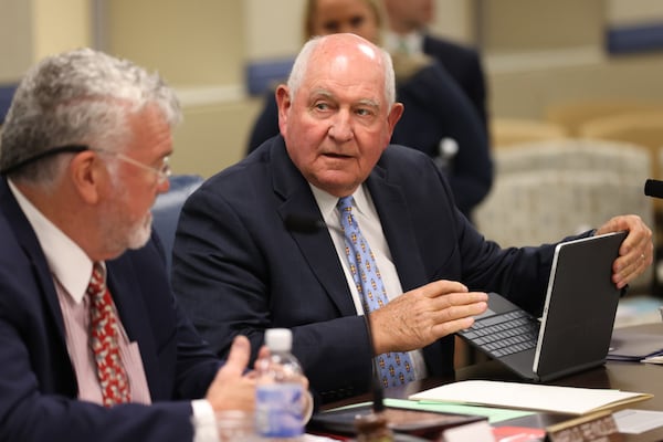 University System of Georgia Chancellor Sonny Perdue talks with Georgia Board of Regents Chairman Harold Reynolds before the beginning of the last meeting of the school year on Tuesday, May 10, 2022. (Miguel Martinez / miguel.martinezjimenez@ajc.com)