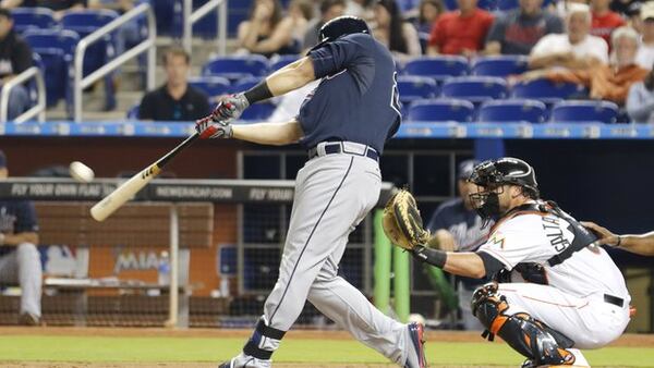 Chris Johnson connects on this RBI double off the left-field wall Tuesday, as the Braves scored seven first-inning runs and chased Marlins starter Mat Latos from the game before he could record his third out. (AP photo)