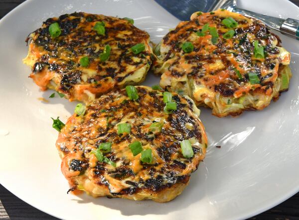 Okonomiyaki with Shrimp. This recipe for small, easily manageable pancakes is inspired by one in "The Dinner Plan" by Kathy Brennan and Caroline Campion (Abrams, $29.99). You can make them any size you want. Our version is topped simply with mayo, Sriracha and scallions. Feel free to embellish with okonomiyaki sauce, bonito flakes (katsuobushi), Japanese pickled ginger (beni shoga) or seaweed flakes (aonoriko). Food styling by Wendell Brock / Chris Hunt /For The AJC