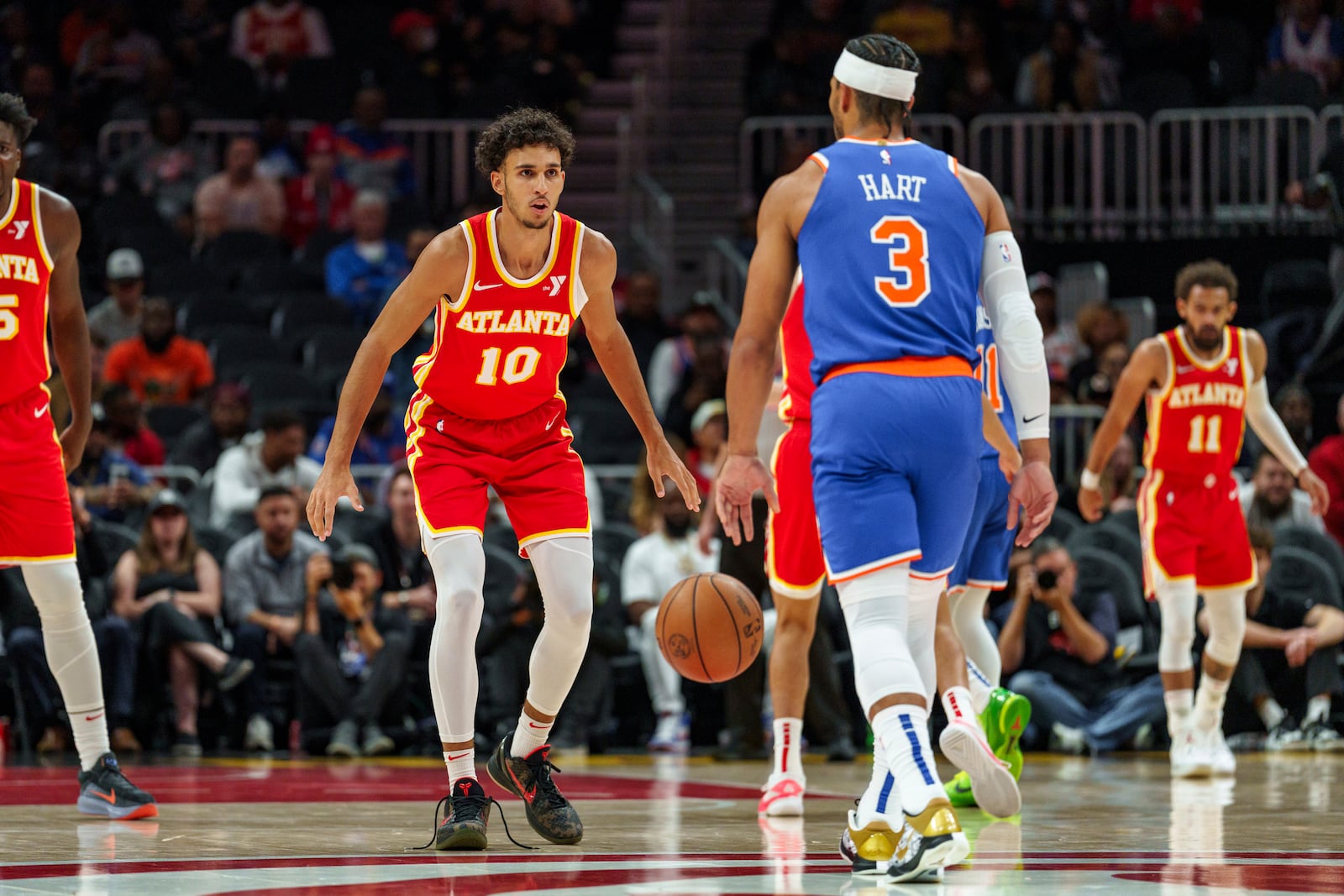 Atlanta Hawks forward Zaccharie Risacher (10) plays defense against New York Knicks guard Josh Hart (3) during the first half of an NBA basketball game, Wednesday, Nov. 6, 2024, in Atlanta. (AP Photo/Jason Allen)