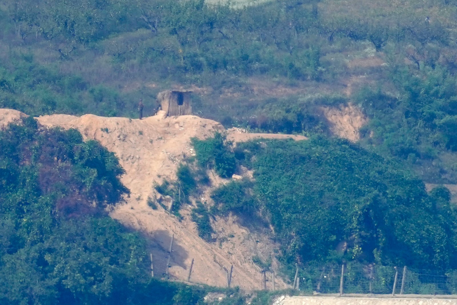 North Korean soldiers stand at the North's military guard post, seen from Paju, South Korea, Wednesday, Oct. 9, 2024. (AP Photo/Lee Jin-man)