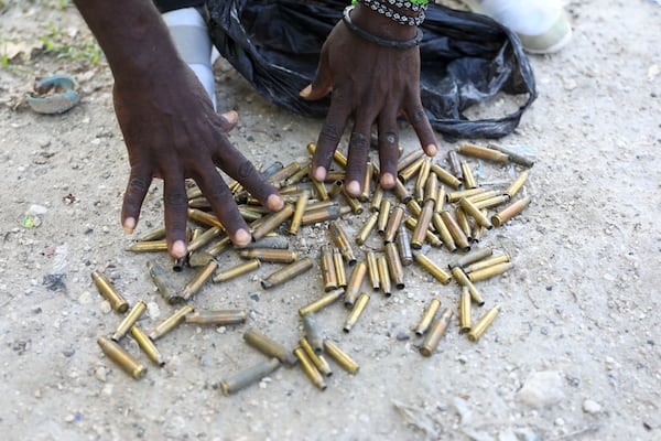 FILE - A man shows bullet casings he collected from the streets near his home days after an armed gang attack on Pont-Sonde, Haiti, Tuesday, Oct. 8, 2024. (AP Photo/Odelyn Joseph, File)