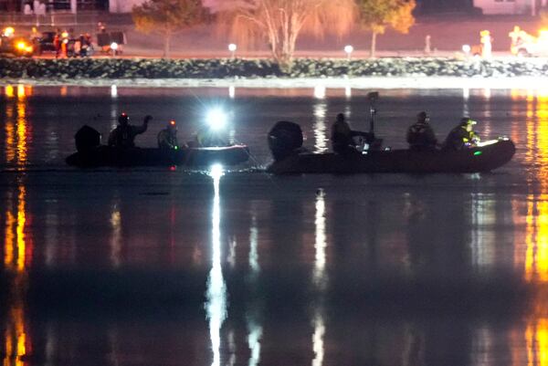 Boats work the scene in the Potomac River near Ronald Reagan Washington National Airport, Thursday, Jan. 30, 2025, in Arlington, Va. (AP Photo/Alex Brandon)