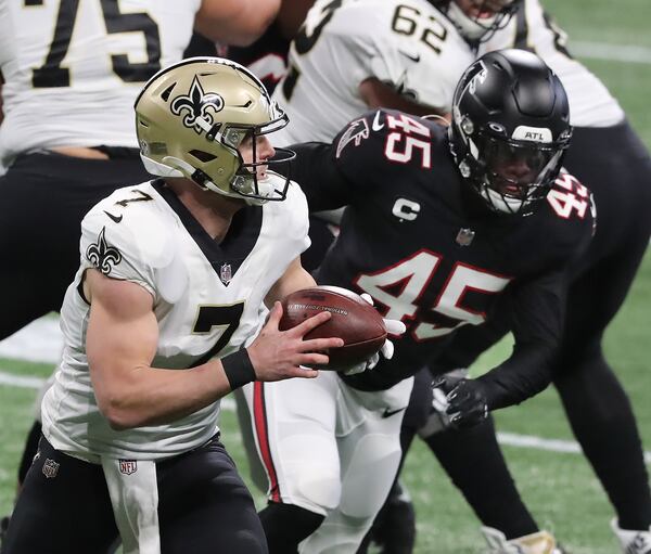 Saints quarterback Taysom Hill breaks away from Falcons linebacker Deion Jones for a long gain into Falcons territory during the first quarter Sunday, Dec. 6, 2020, at Mercedes-Benz Stadium in Atlanta. (Curtis Compton / Curtis.Compton@ajc.com)