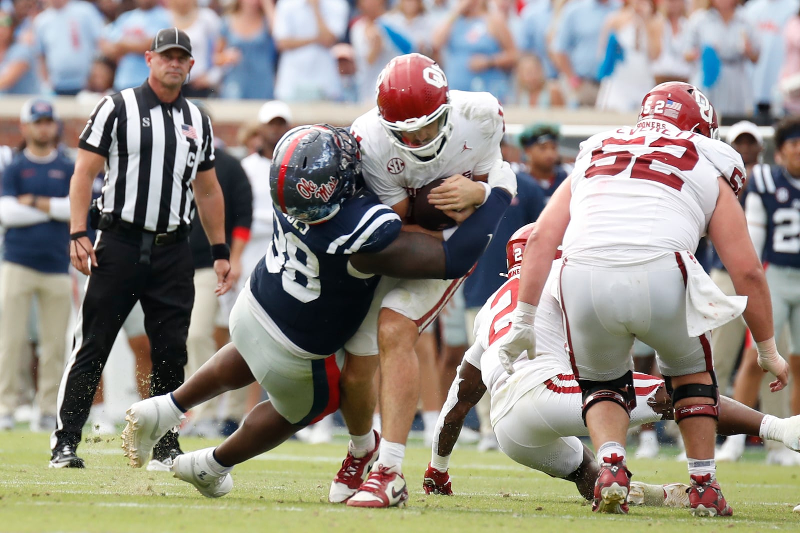 University of Mississippi defensive tackle JJ Pegues (38) tackles University of Oklahoma quarterback Jackson Arnold (11) during the second half of an NCAA college football game, Saturday, Oct. 26, 2024, in Oxford, Miss. (AP Photo/Sarah Warnock)