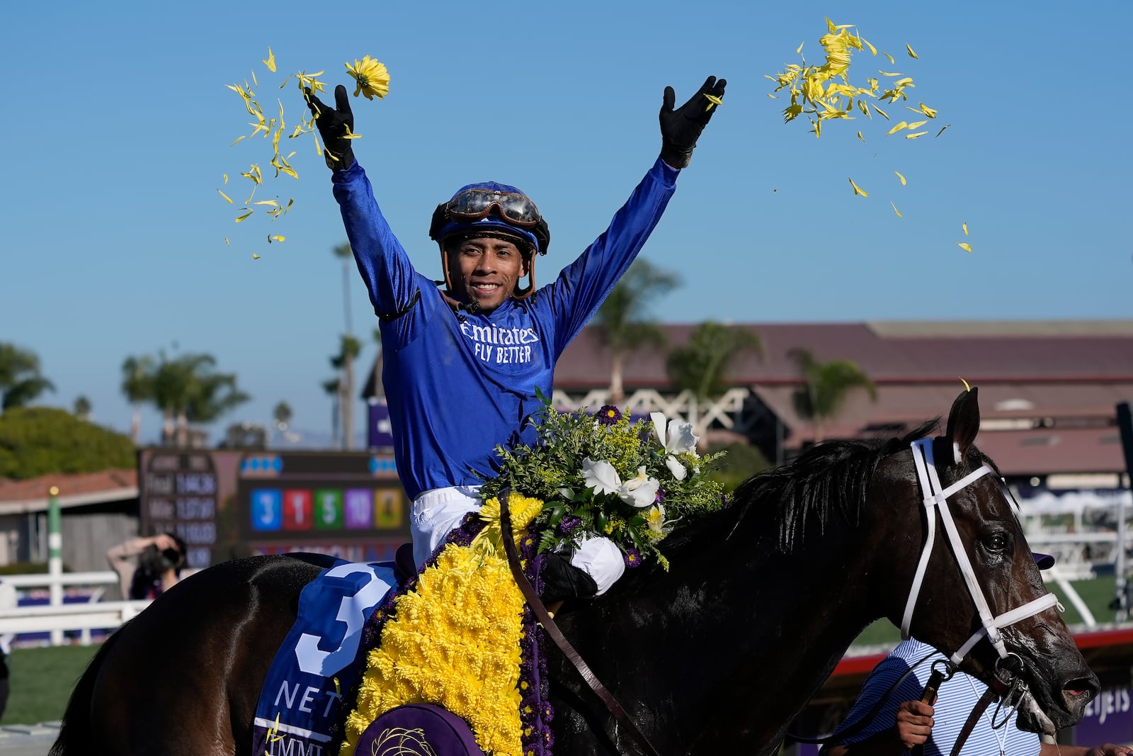 Manuel Franco celebrates after riding Immersive to victory in the Breeders' Cup Juvenile Fillies horse race at Santa Anita Park in Del Mar, Calif., Friday, Nov. 1, 2024. (AP Photo/Gregory Bull)