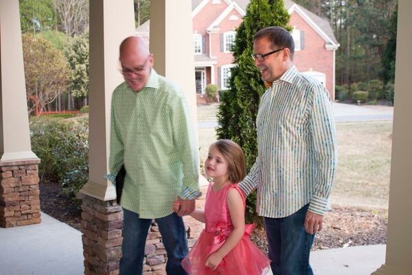 Katherine Bass (center) walks into her dads’ wedding reception holding their hands. Ken Adcox and Jim Bass, Katherine’s uncle, adopted her and two of her siblings when Jim’s sister could no longer care for them. A growing number of children like Katherine are being caught in the drug epidemic sweeping the country. CONTRIBUTED