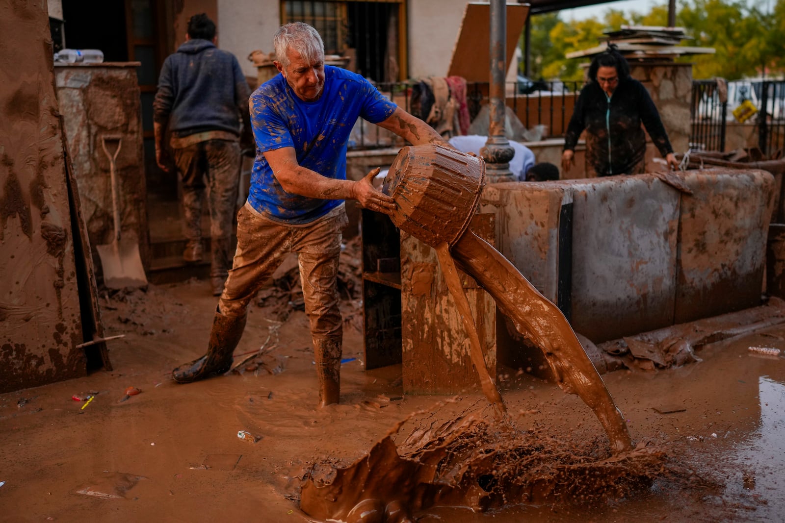 A man cleans his house affected by floods in Utiel, Spain, Wednesday, Oct. 30, 2024. (AP Photo/Manu Fernandez)