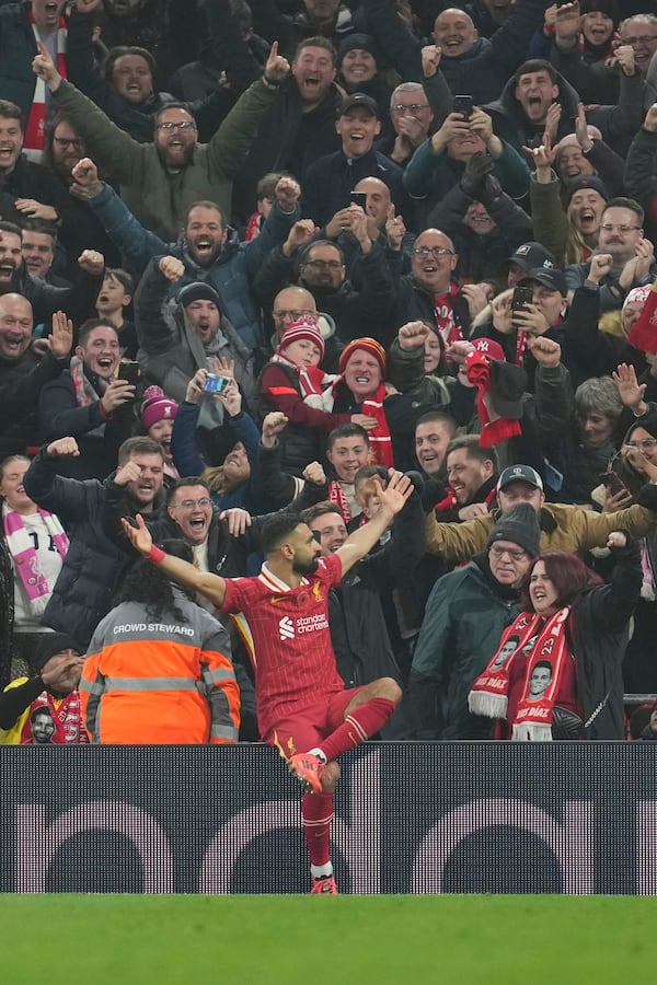 Liverpool's Mohamed Salah celebrates after scoring his side's 2nd goal against Aston Villa during the English Premier League soccer match at the Anfield stadium in Liverpool, Saturday, Nov. 9, 2024. (AP Photo/Jon Super)