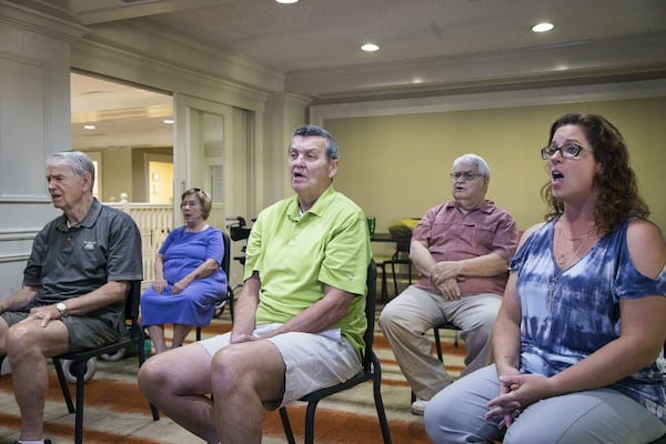 Members of the Singing with Parkinson’s choir rehearse “The Star-Spangled Banner.” The group will sing at “Parkinson’s Moving Day,” an annual fundraising event at Piedmont Park that raises awareness about Parkinson’s disease. ALYSSA POINTER / ALYSSA.POINTER@AJC.COM