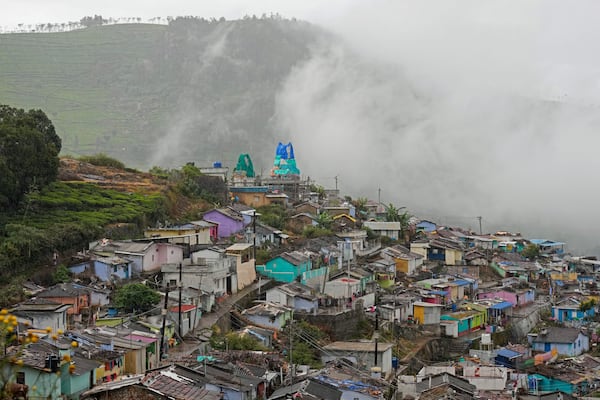 Mist covers the tea estates over a thickly populated area in Udhagamandalam in Nilgiris district, India, Thursday, Sept. 26, 2024. (AP Photo/Aijaz Rahi)