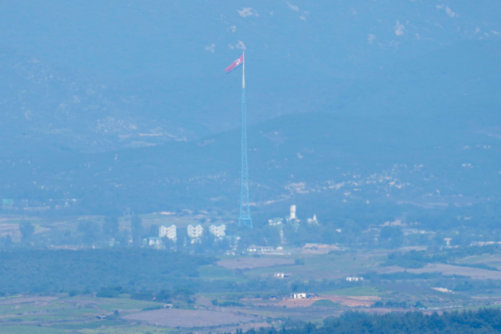 A North Korean flag flutters in the wind atop a 160-meter (525-foot) tower in the North's Kijong-dong village near the truce village of Panmunjom, seen from Paju, South Korea, near the border with North Korea, Wednesday, Oct. 9, 2024. (AP Photo/Lee Jin-man)