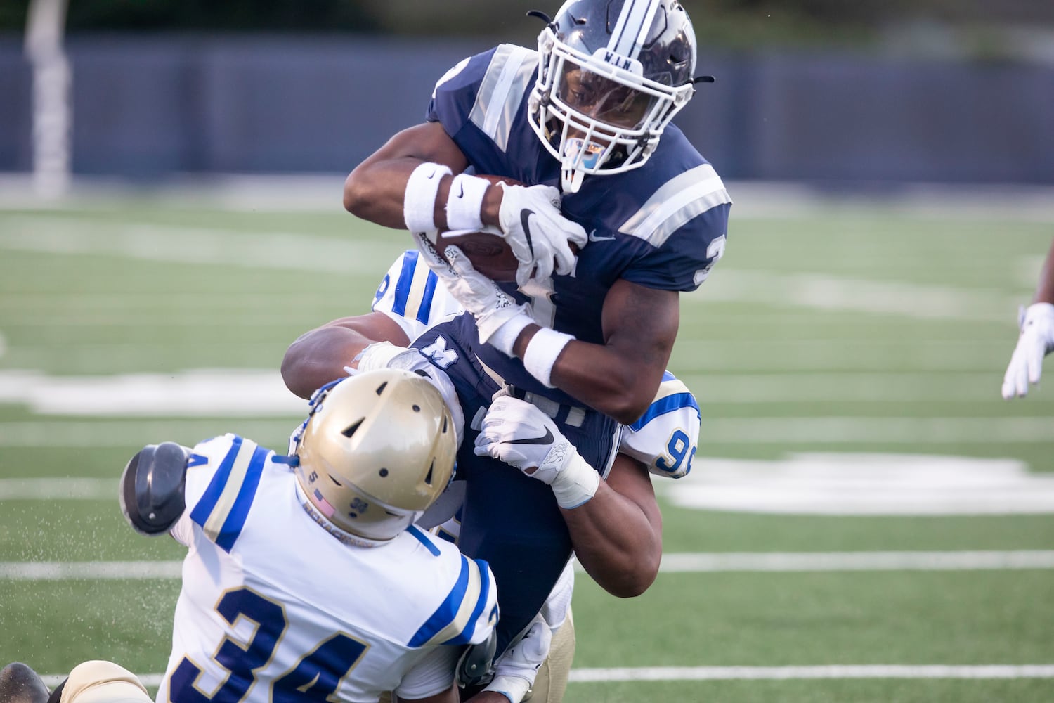 Marietta High School's David Moscovoy (3) is tackled at a high school football game between McEachern High School and Marietta High School at Northcutt Stadium in Marietta, Ga., on Friday, Sept. 3, 2021.  (Photo/ Jenn Finch, The Atlanta Journal-Constitution)