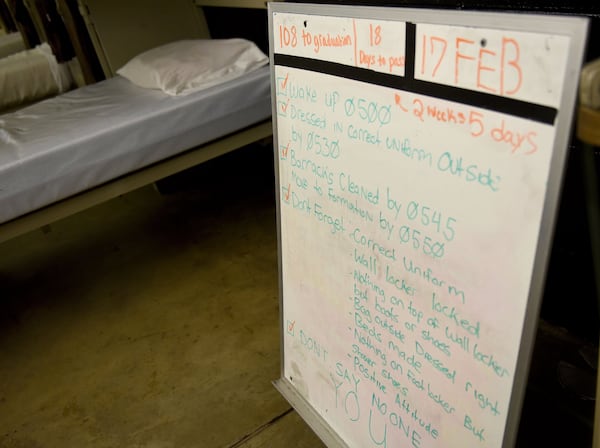 A dry erase board set up in a barracks building at the Fort Stewart Youth Challenge Academy reflects the strict daily regimen of the cadets housed there. They wake up at 5 a.m. for physical training, with lights out at 9 p.m. RYON HORNE / RHORNE@AJC.COM