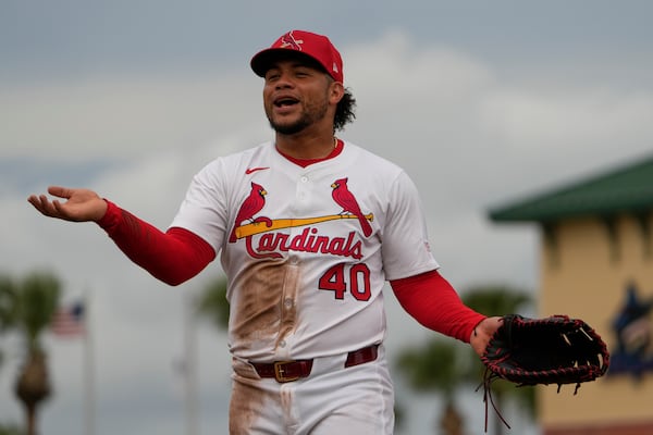 St. Louis Cardinals first baseman Willson Contreras talks with teammates in the dugout during the fourth inning of a spring training baseball game against the New York Mets Monday, Feb. 24, 2025, in Jupiter, Fla. (AP Photo/Jeff Roberson)