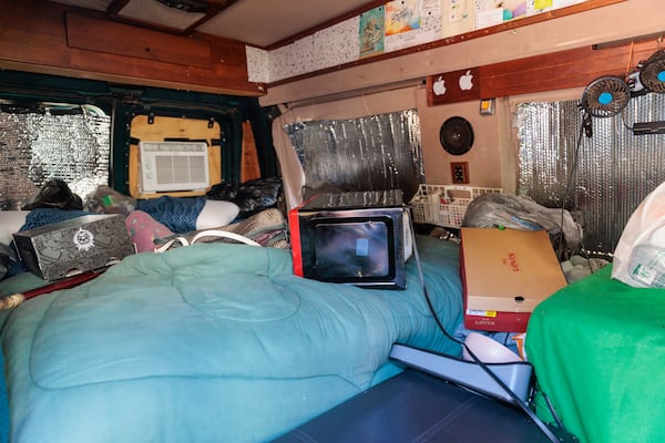 Synya Bradshaw, 52, and Maria Hairston, 35, lived in their van (pictured) before moving into their new apartment in Jonesboro on Thursday, November 3, 2022.   (Arvin Temkar / arvin.temkar@ajc.com)