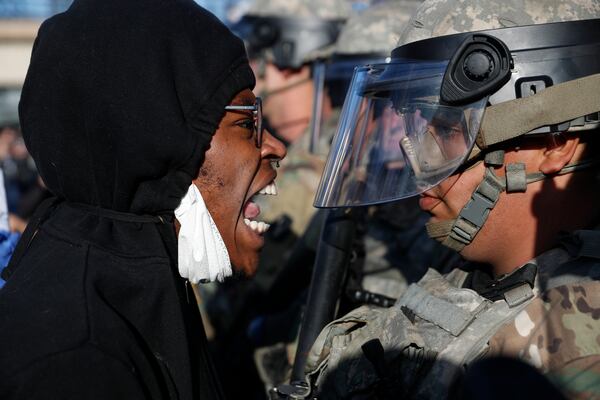 A protester yells at a member of the Minnesota National Guard.