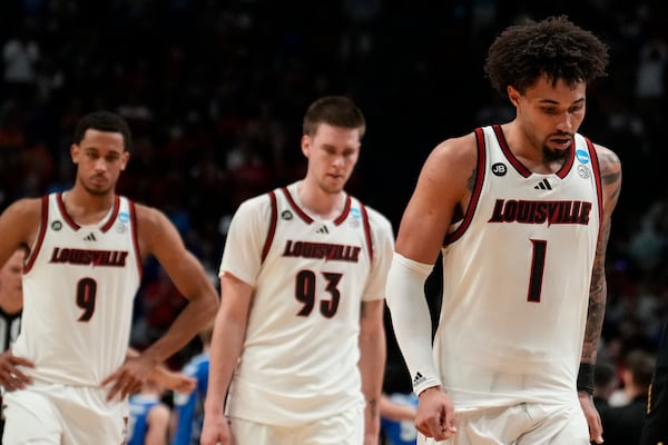 Louisville players walk off the court after the first round of the NCAA college basketball tournament against Creighton, Thursday, March 20, 2025, in Lexington, Ky. (AP Photo/Brynn Anderson)