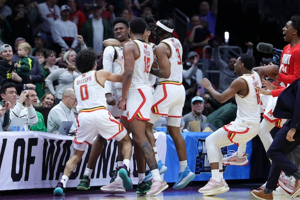 Maryland center Derik Queen, center, reacts with teammates after making the game-winning shot against Colorado State during the second half in the second round of the NCAA college basketball tournament, Sunday, March 23, 2025, in Seattle. (AP Photo/Ryan Sun)