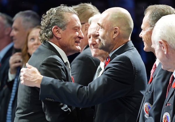 2024 Hockey Hall of Fame inductee Jeremy Roenick, left, is greeted by Ed Belfour during a ceremony prior to NHL hockey game action between the Detroit Red Wings and the Toronto Maple Leafs in Toronto, Friday, Nov. 8, 2024. (Frank Gunn/The Canadian Press via AP)