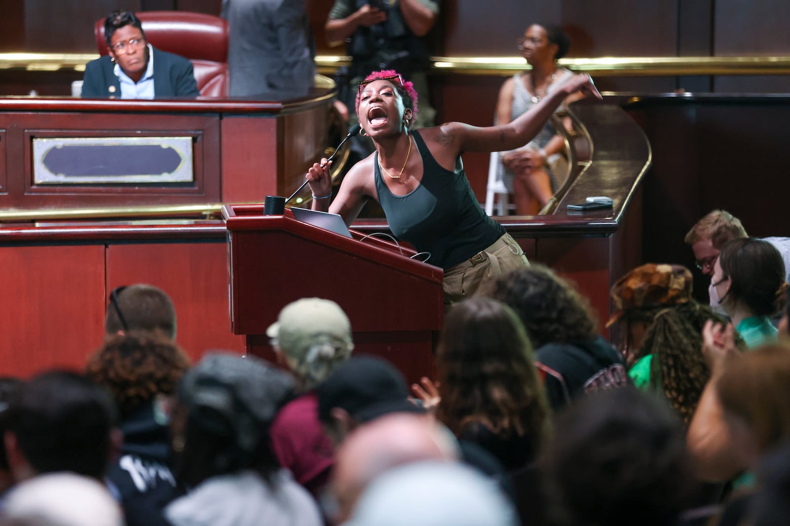 A protestor speaks to fellow protestors during the public comment portion ahead of the final vote to approve legislation to fund the training center at Atlanta City Hall, on Monday, June 5, 2023, in Atlanta. (Jason Getz / Jason.Getz@ajc.com)