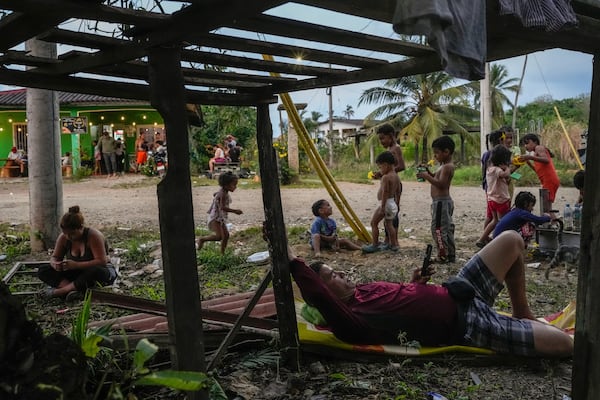 Migrants wait around in a shelter in Palenque, Panama, Wednesday, Feb. 26, 2025. The migrants are returning from southern Mexico after giving up on reaching the U.S., a reverse flow triggered by the Trump administration's immigration crackdown. (AP Photo/Matias Delacroix)