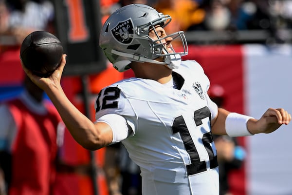 Las Vegas Raiders quarterback Aidan O'Connell (12) passes the ball against the Tampa Bay Buccaneers during the first half of an NFL football game, Sunday, Dec. 8, 2024, in Tampa, Fla. (AP Photo/Jason Behnken)