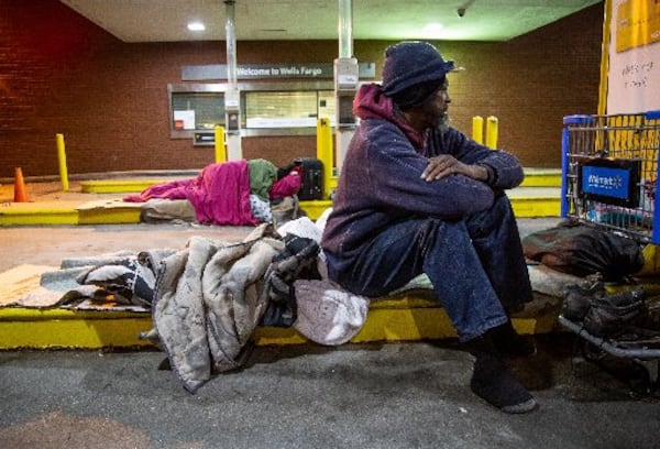 Micheal Russ gets up after spending the night under the drive-thru of a West End bank Wednesday, November 27, 2019. STEVE SCHAEFER / SPECIAL TO THE AJC