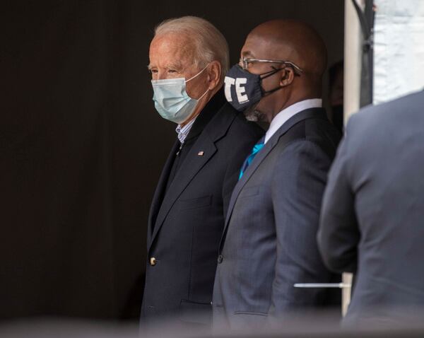 President-elect Joe Biden and Georgia Democrat U.S. Senator candidate the Rev. Raphael Warnock have a moment backstage before they both individually speak during a “Get Ready to Vote” rally  at Pratt-Pullman Yard in Atlanta’s Kirkwood neighborhood, Tuesday, Dec. 15, 2020.  (Alyssa Pointer / Alyssa.Pointer@ajc.com)