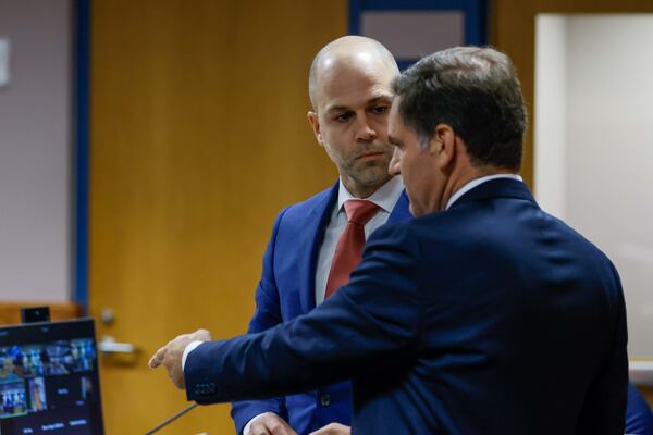 An attorney representing the State Election Board, Robert Thomas (left), speaks with Cobb County attorney Mike Caplan before a hearing Tuesday. (Miguel Martinez/AJC)