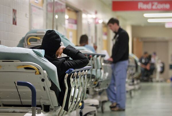 November 8, 2012 - Atlanta, Ga: A patient lays on a stretcher as they wait to be treated in the Red Zone of the Grady Emergency Room at Grady Memorial Hospital Thursday morning in Atlanta, Ga., November 8, 2012. In 2012, Georgia received more than $275 million in federal funds to help hospitals, such as Grady, at least partly make up for the money they lose caring for the poor and uninsured. But much of that money is expected to go away starting in 2014 as part of a requirement under the Affordable Care Act - a move that experts say could threaten the financial stability of Georgia's safety net hospitals.  JASON GETZ / JGETZ@AJC.COM