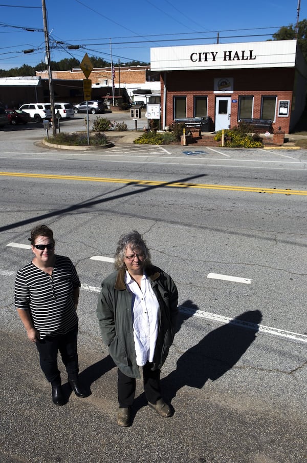 Catherine Corkren (left), 47, of Atlanta and Sondra Moore, 47, of Hoschton, Ga., pose for a portrait across the road from Statham City Hall in Statham, Ga., on Wednesday, Oct. 24, 2018.