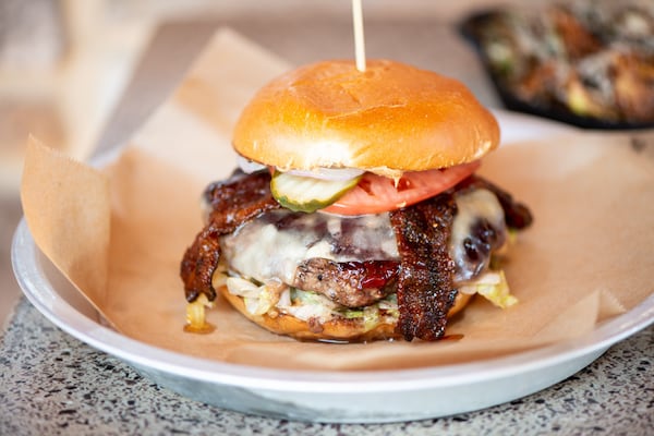 PB and J Burger with a half pound beef patty, candied bacon, Havarti, peanut butter, grape jelly, lettuce, tomato, onion, and pickles. Photo credit- Mia Yakel.